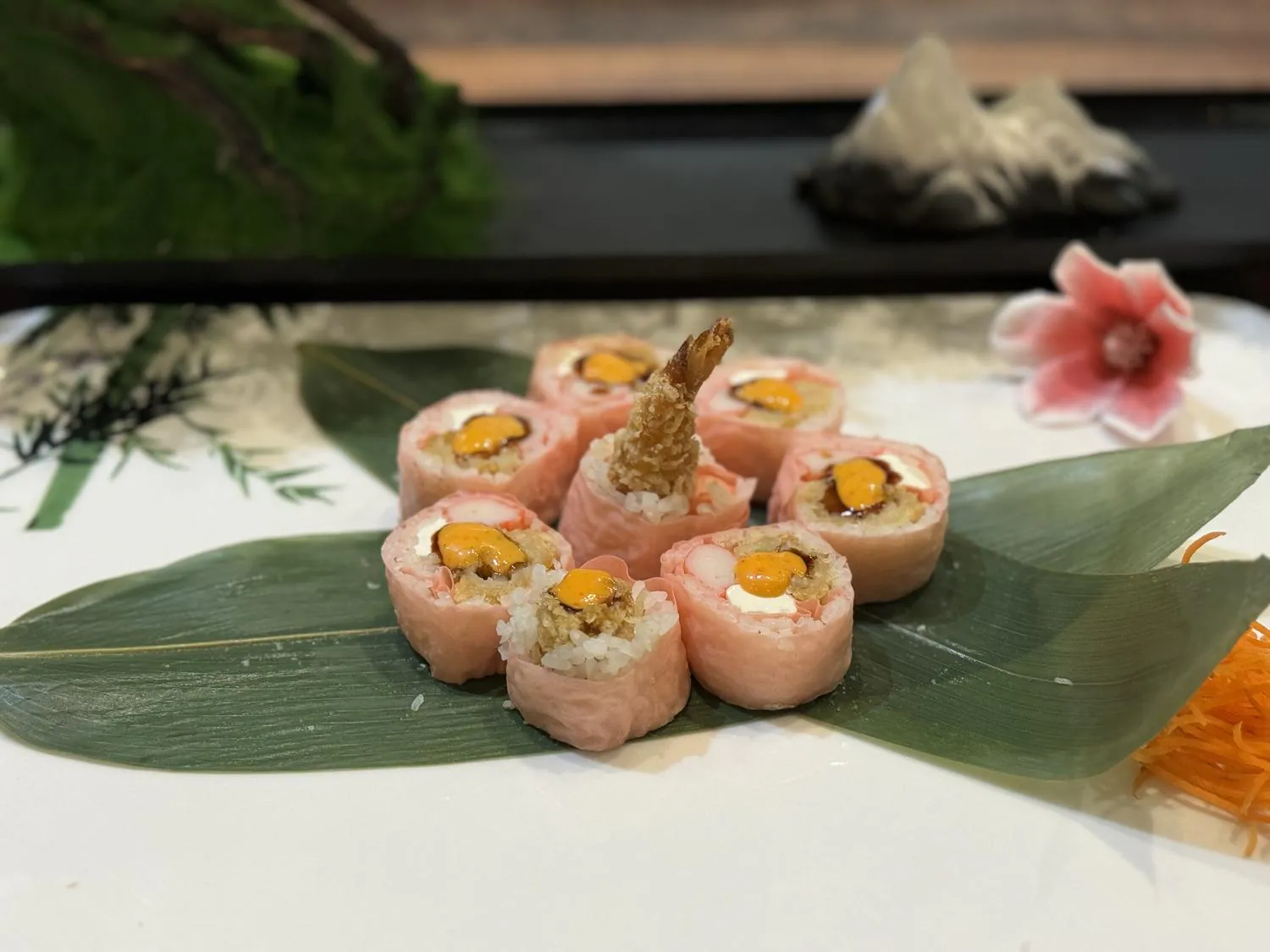 Sushi roll wrapped in pink soy paper with shrimp tempura and mango at Sushi Kingdom Glen Allen, a Japanese Restaurant in Glen Allen